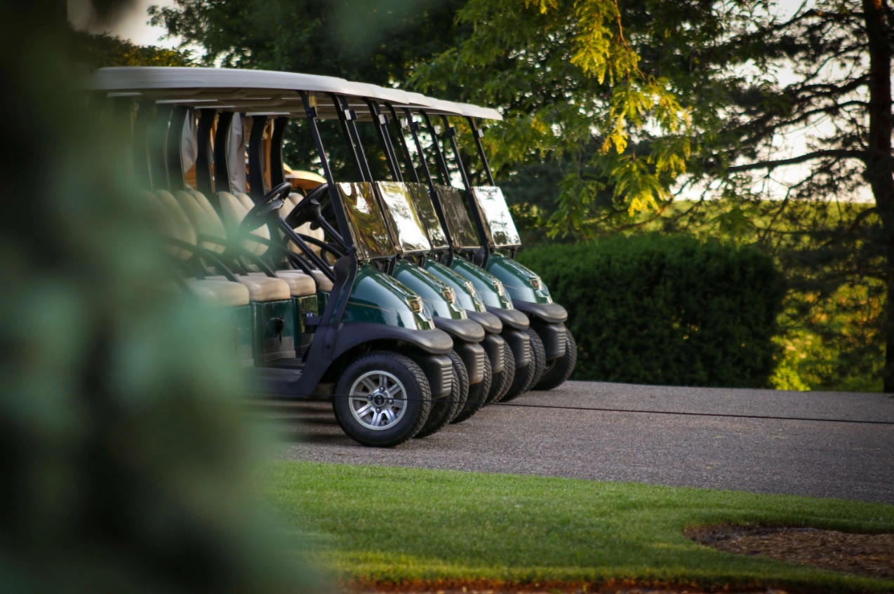 5 golf buggies lined up side by side