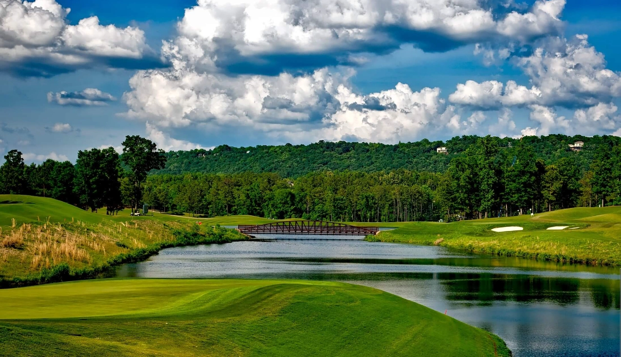 Another fairway shot with a view of the river that runs along side on a sunny day with some cloud cover